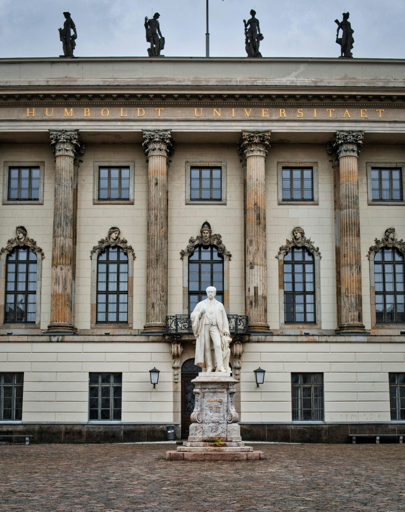 Facade of Humboldt University in Berlin featuring statues and classical architecture.